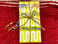 Festival Junk Journal Cover with colorful paper flags tied with twine.